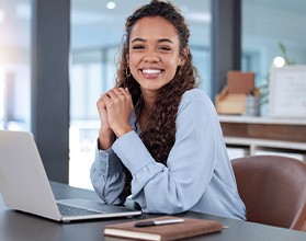 Woman smiling while working in office