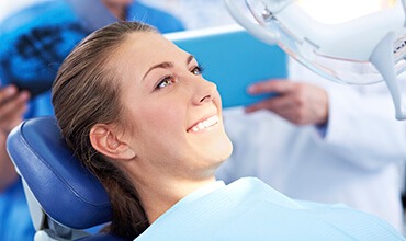 Young female patient smiling in dental chair